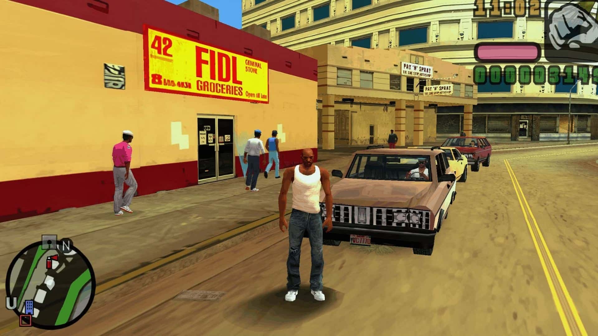 Foto do protagonista de GTA Vice City Stories em frente a um Print Work e um Restaurante. (Divulga&ccedil;&atilde;o / Internet)
